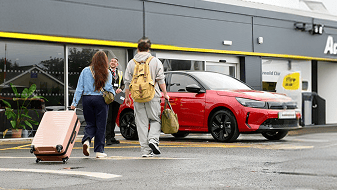 Couple walking towards car hire branch